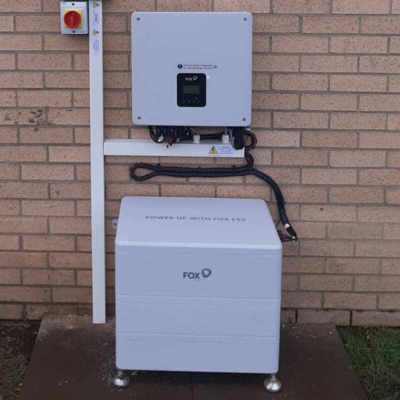 Battery storage unit against brick wall